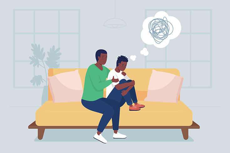 man hugging child on couch