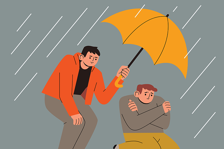 Person holding an umbrella for another person