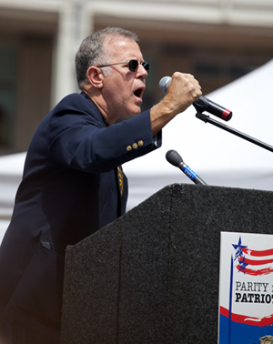 Kenny Allred speaking at the Parity for Patriots Rally in Seattle in June 2012.