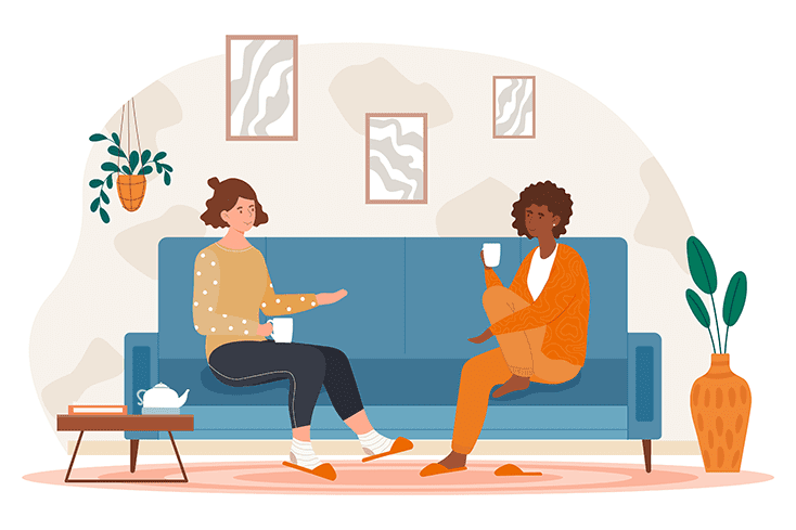 two female friends drinking tea at home